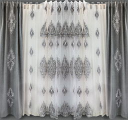 Direct curtains of gray velvet with applique and the light tulle from a thin translucent organza with the embroidery