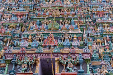 Madurai, India - October 19, 2013: Closeup of part of the North Gopuram facade. Among many more statues, two eight-armed Dwarapalakas.