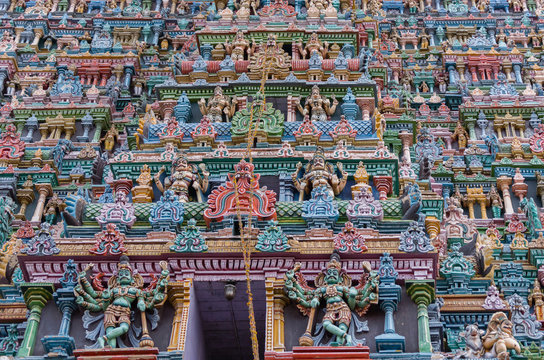 Madurai, India - October 19, 2013: Closeup of part of the North Gopuram facade. Among many more statues, two eight-armed Dwarapalakas.