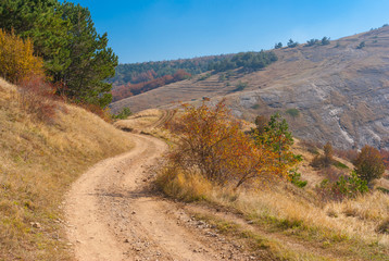 Fall Landscape with earth road in mountain pasture Demerdzhi, Crimean oeninsula