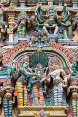 Madurai, India - October 19, 2013: Closeup of the wedding scene of Meenakshi and Shiva, while Vishnu gives his sister away. Facade of West Gopuram at Meenakshi Temple.