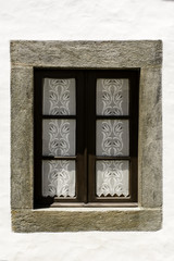Fototapeta na wymiar Portugal, whitewashed curtained window
