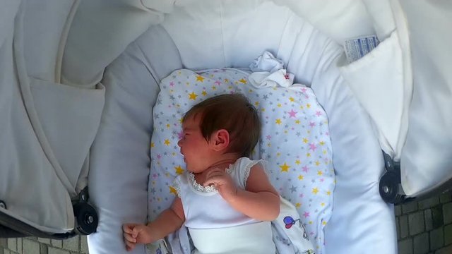 Baby lying in the pram and crying