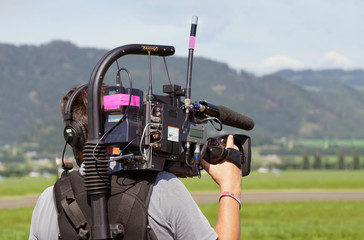 Cameraman on an airfield - obrazy, fototapety, plakaty