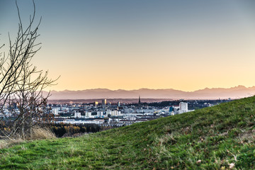 skyline of Linz, Austria with mountains at sun dawn