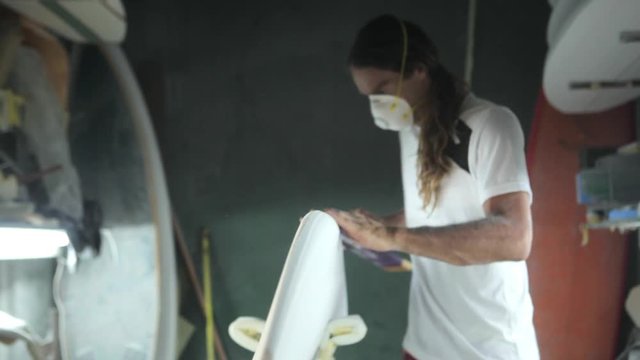 Surfboard shaping, Shaper using a foam sander to shape the side of the surfboard