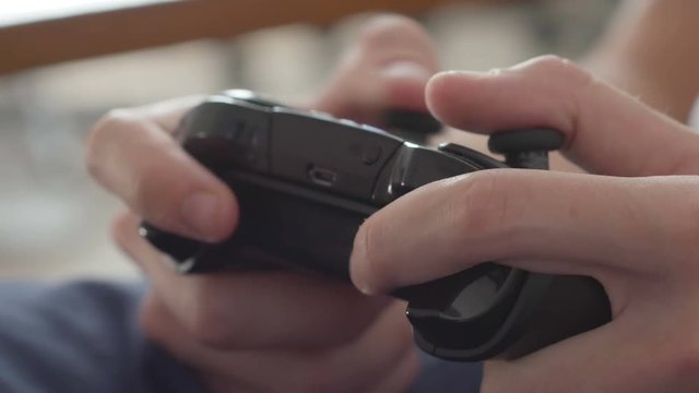 Close up of boy hands using game controller, in the end throwing the controller, angry close up