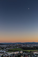 skyline of Linz, Austria with mountains at sun dawn