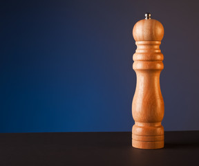 pepper grinder, blue background.
