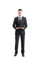 Young and confident business man holding a tablet