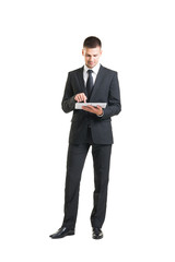 Fototapeta premium Young and confident business man holding a tablet