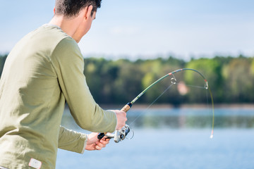 Fisherman at lake fishing for sport