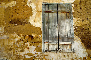 Closed window with old wooden shutters.