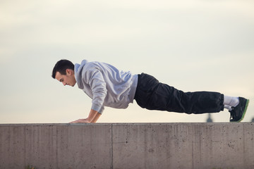 Young athlete is exercising outside.