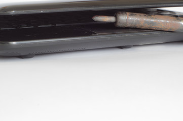 soldering iron vintage and broken computer on white background