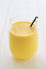 Vanilla milk in glass with vanilla pod