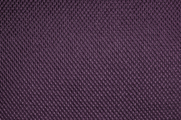 Purple fishnet cloth material as a texture background. Nylon texture pattern or nylon background for design with copy space for text or image.