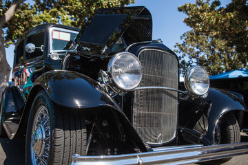 Part of a black old car with headlamp