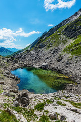 Scenic view of clear pool of water atop mountain