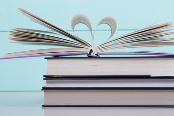 stack of books on a turquoise background. love of reading