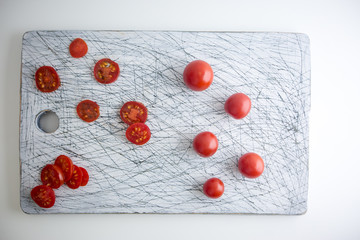Naklejka na ściany i meble Small red cherry tomatoes spill out of on old wooden table in r