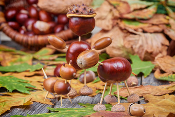 Small creatures made of chestnuts and acorns. Autumnal decoratio