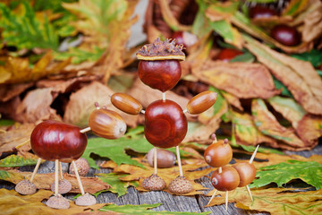 Small creatures made of chestnuts and acorns. Autumnal decoratio