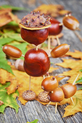 Small creatures made of chestnuts and acorns. Autumnal decoratio