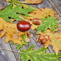 Small creatures made of chestnuts and acorns. Autumnal decoratio