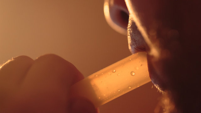 young bearded man smokes a hookah extreme close-up