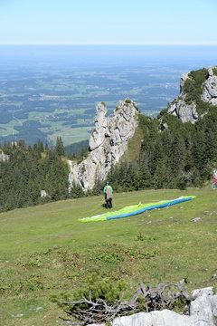 one second before the start, paraglider in beautiful bavarian landscape just before the start