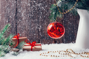 Composition with Christmas decorations in vase on dark wooden background