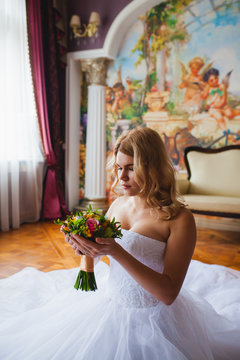 Bride portrait in beautiful interior with bridal bouquet
