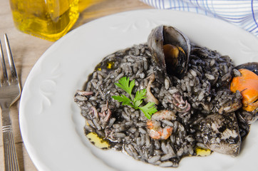 Fototapeta na wymiar Black risotto plate with seafood.