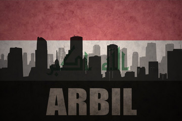 abstract silhouette of the city with text Arbil at the vintage iraqi flag background