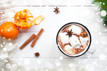 Hot chocolate with marshmallows in a ceramic cup, cinnamon stick