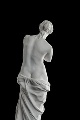 a statue of Venus, plaster column on a black background © Kozlik_mozlik