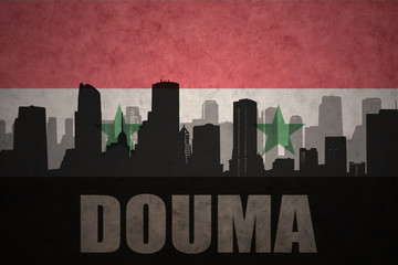 abstract silhouette of the city with text Douma at the vintage syrian flag background