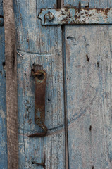 Vintage blue wooden background with a metal hook