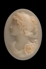 plastic face in a medallion on a black background