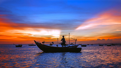 sea sunset with boat silhouette, man