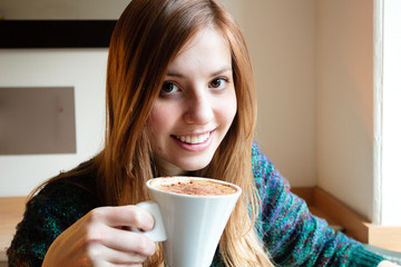 Girl taking a cup of coffee