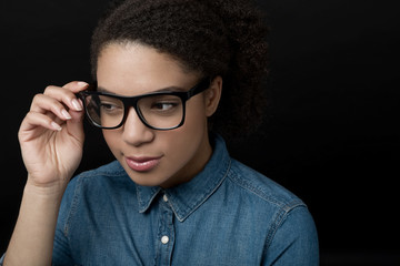 Woman holding glasses isolated on black background