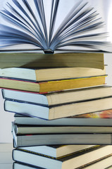 stack of books and opened book