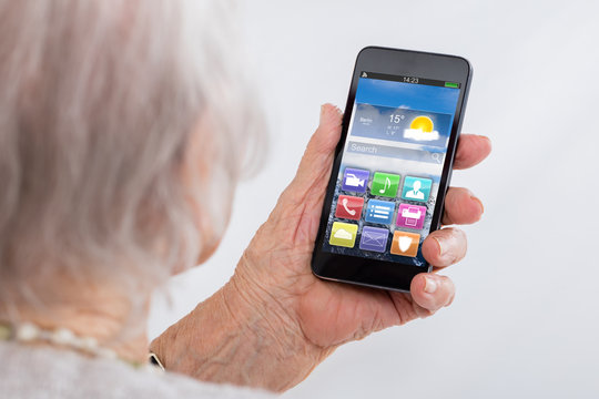 Close-up Of Senior Woman Using Smartphone