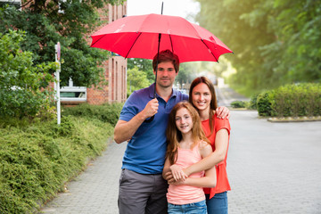 Portrait Of A Couple With Their Daughter