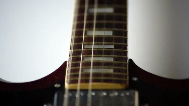 Closeup of guitar strings vibrating when being strummed