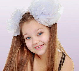 Beautiful little girl with white bows on the head