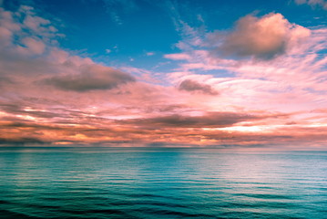 Multicolored surreal sunset view of a sea horizon. Beautiful landscape photography. Background tecture for travel and adventure.