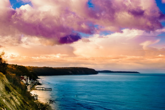 Multicolored surreal sunset view of a rocky coastline. Beautiful landscape photography. Background tecture for travel and adventure. - Powered by Adobe